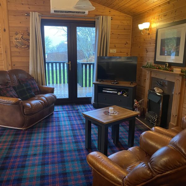 Living room with updated furniture and new TV Patio has a view of Loch Lomond. We're in Rowardennan. Visit Loch Lomond Holiday Lodge