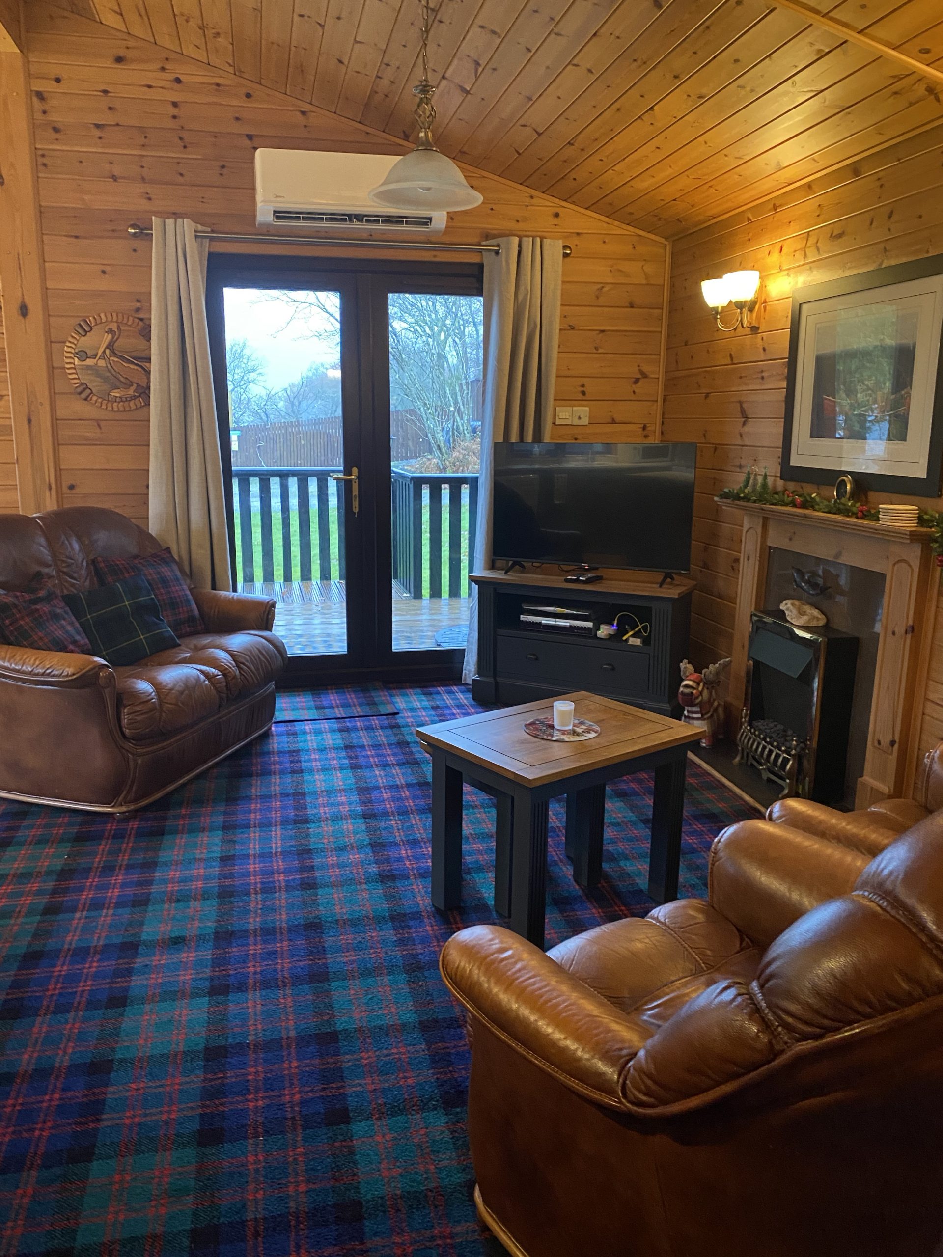 Living room with updated furniture and new TV Patio has a view of Loch Lomond. We're in Rowardennan. Visit Loch Lomond Holiday Lodge